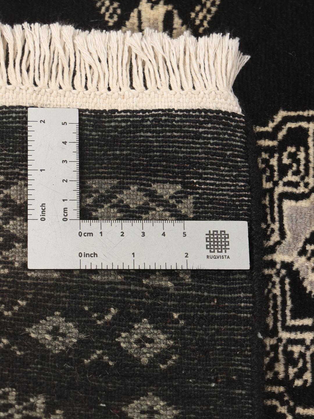 Hand-knotted Pakistan Bokhara runner in black with traditional geometric patterns