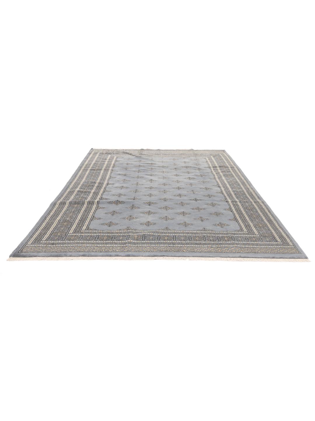 A hand-knotted Pakistan Bokhara rug with a blue field and repeating motifs.