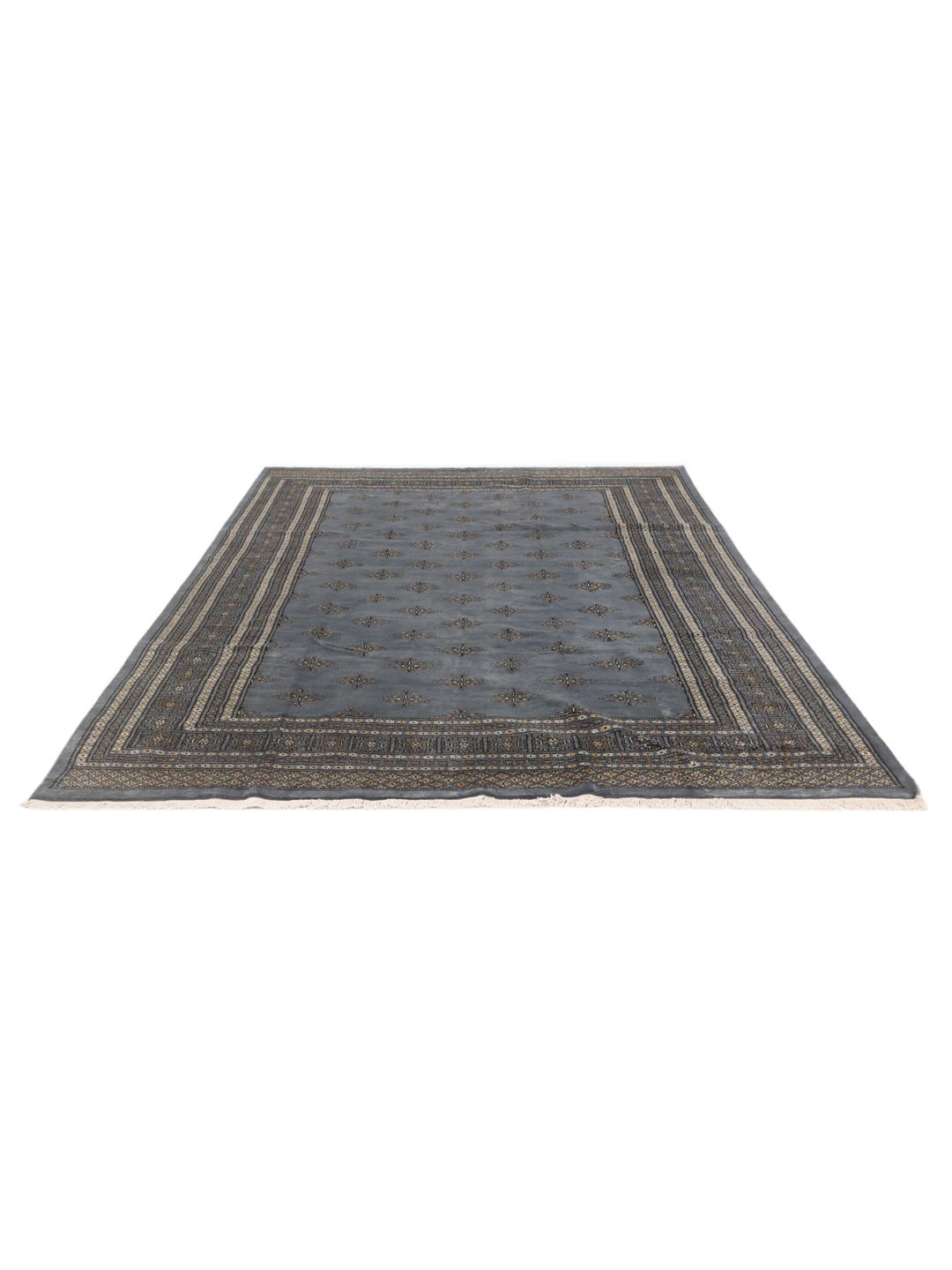A hand-knotted Pakistan Bokhara rug with a blue field and repeating motifs.