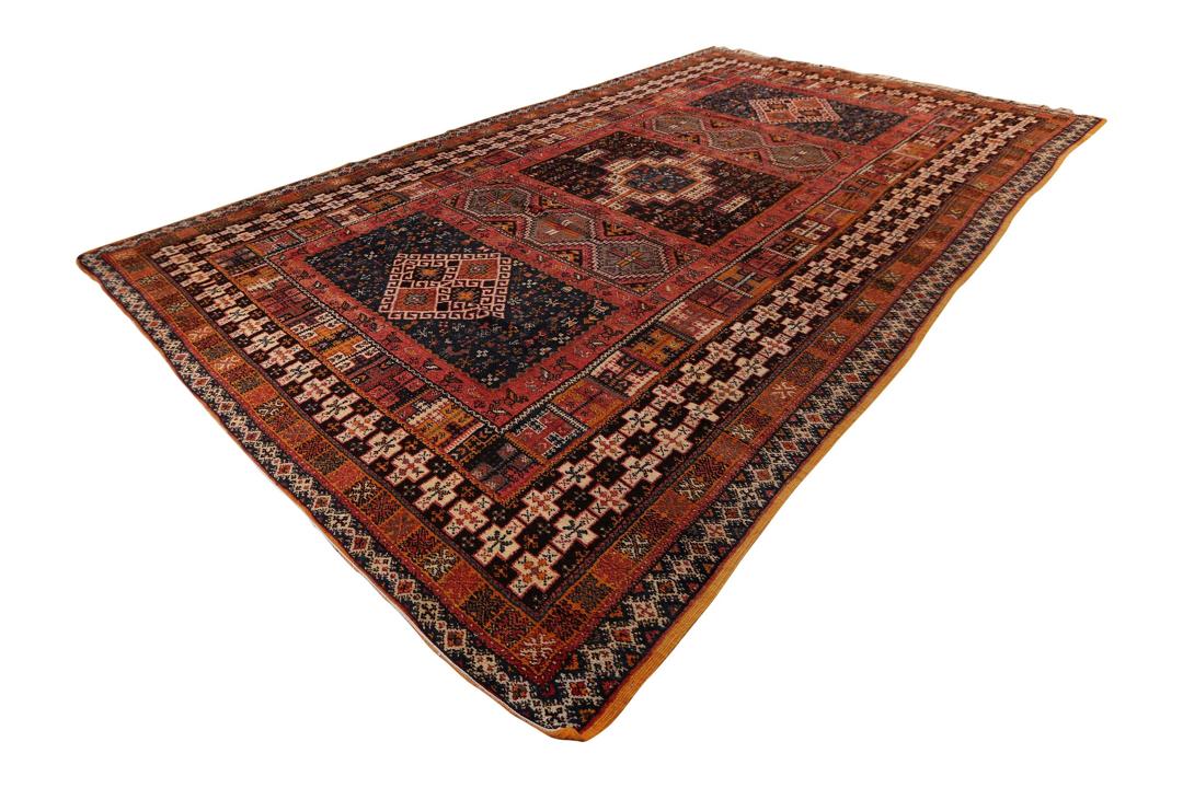 Vintage marokkanischer Berberteppich mit geometrischen Stammesmustern in mehrfarbiger Wolle.