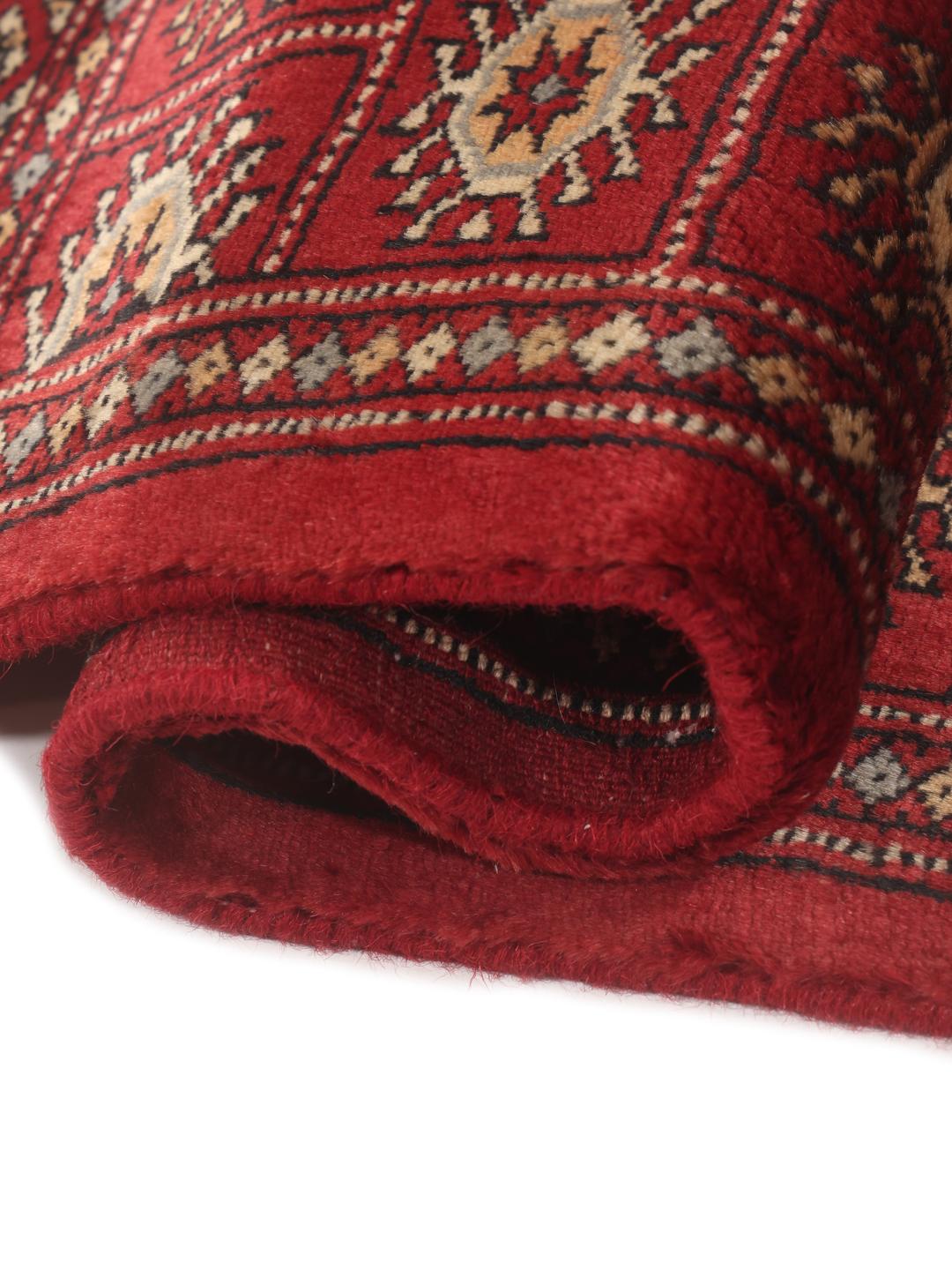 Hand-knotted Pakistan Bokhara 3ply rug in dark-red with repeating medallion motifs