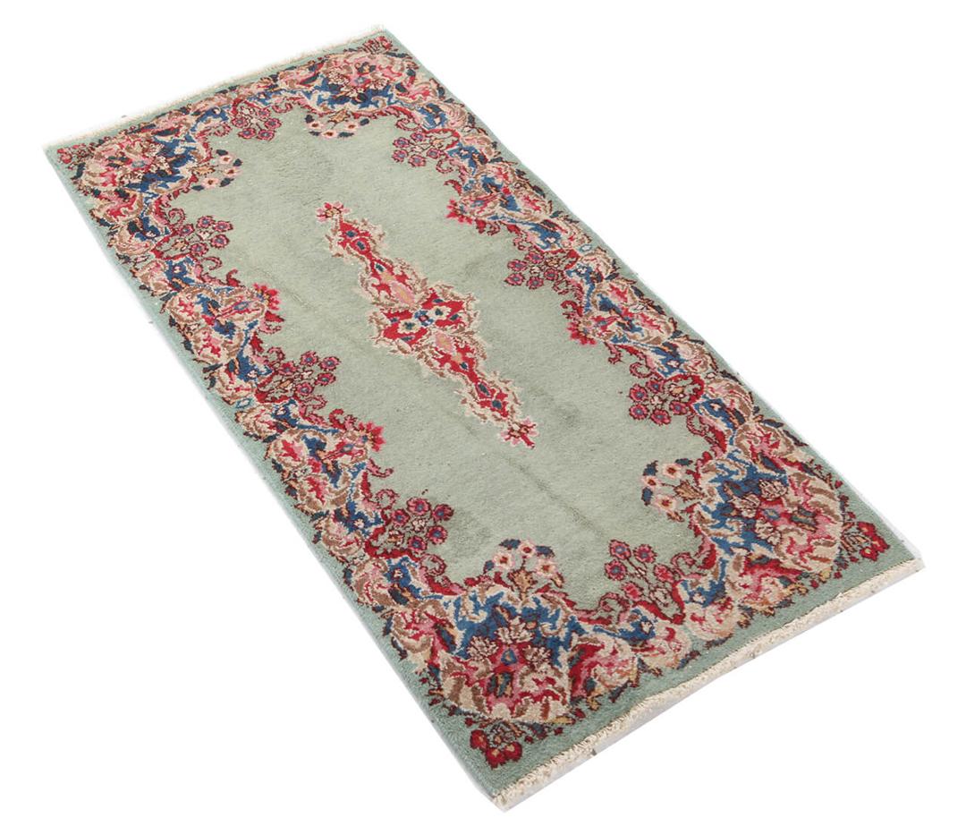 Antique Kerman rug from the Middle East in light-green with floral motifs