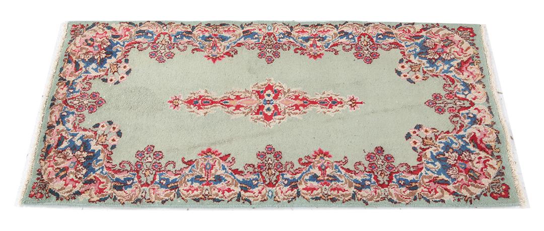 Antique Kerman rug from the Middle East in light-green with floral motifs