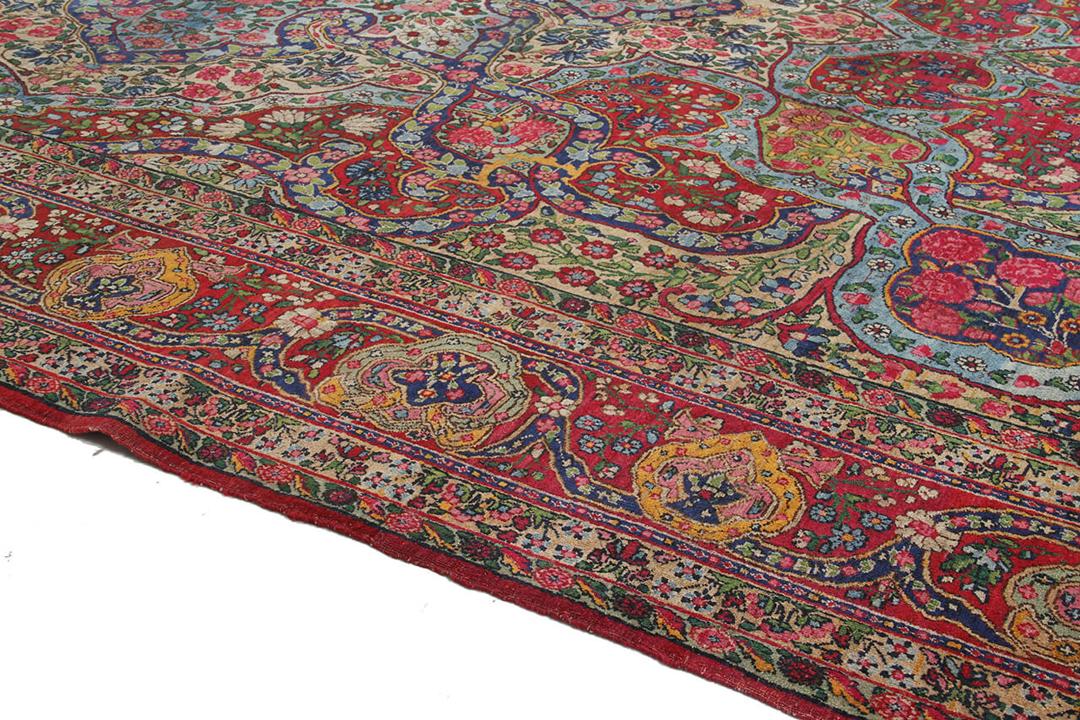 Handgeknoopt tapijt uit het Midden-Oosten in rood en blauw met bloemenmedaillonpatroon