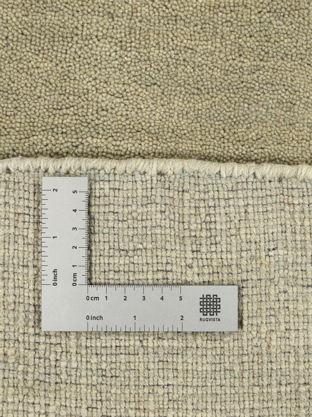 Round light green rug with a soft pile texture