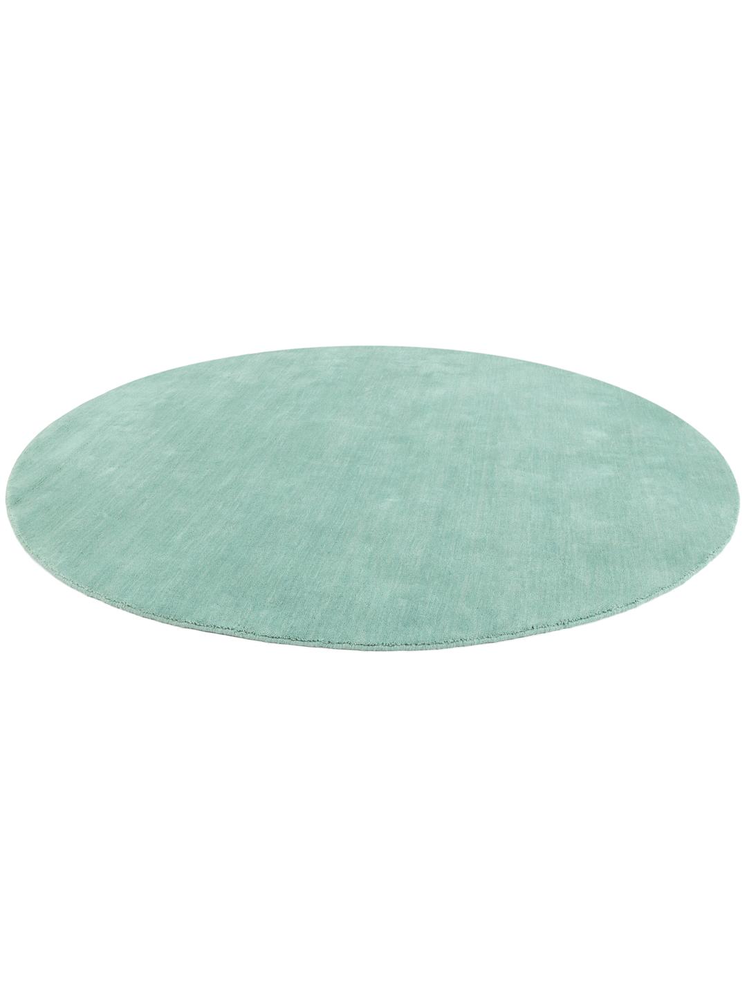 Round teal rug made from wool