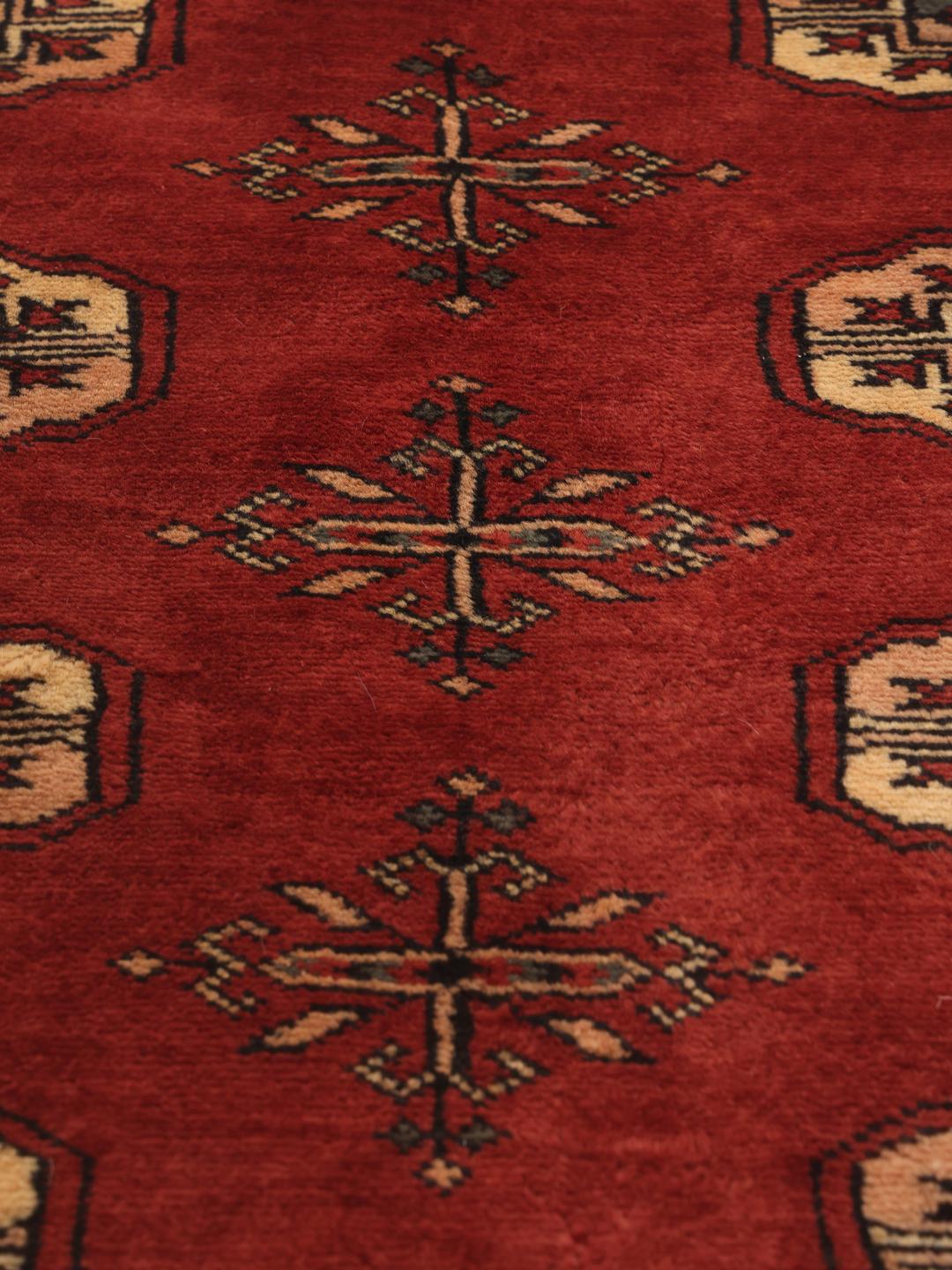 Hand-knotted Pakistan Bokhara 3ply rug in red with traditional motifs