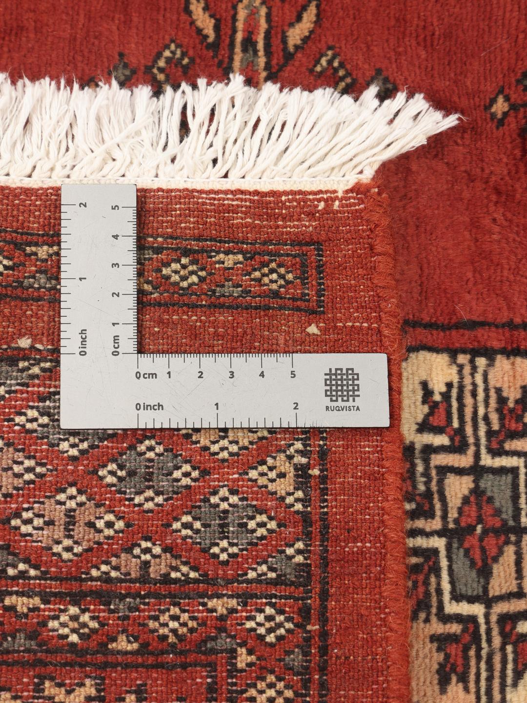 Hand-knotted Pakistan Bokhara 3ply rug in red with traditional motifs