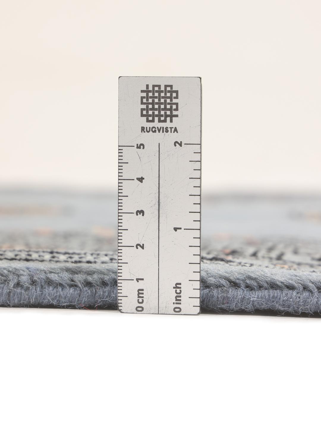 A hand-knotted blue runner from Pakistan with a traditional motif
