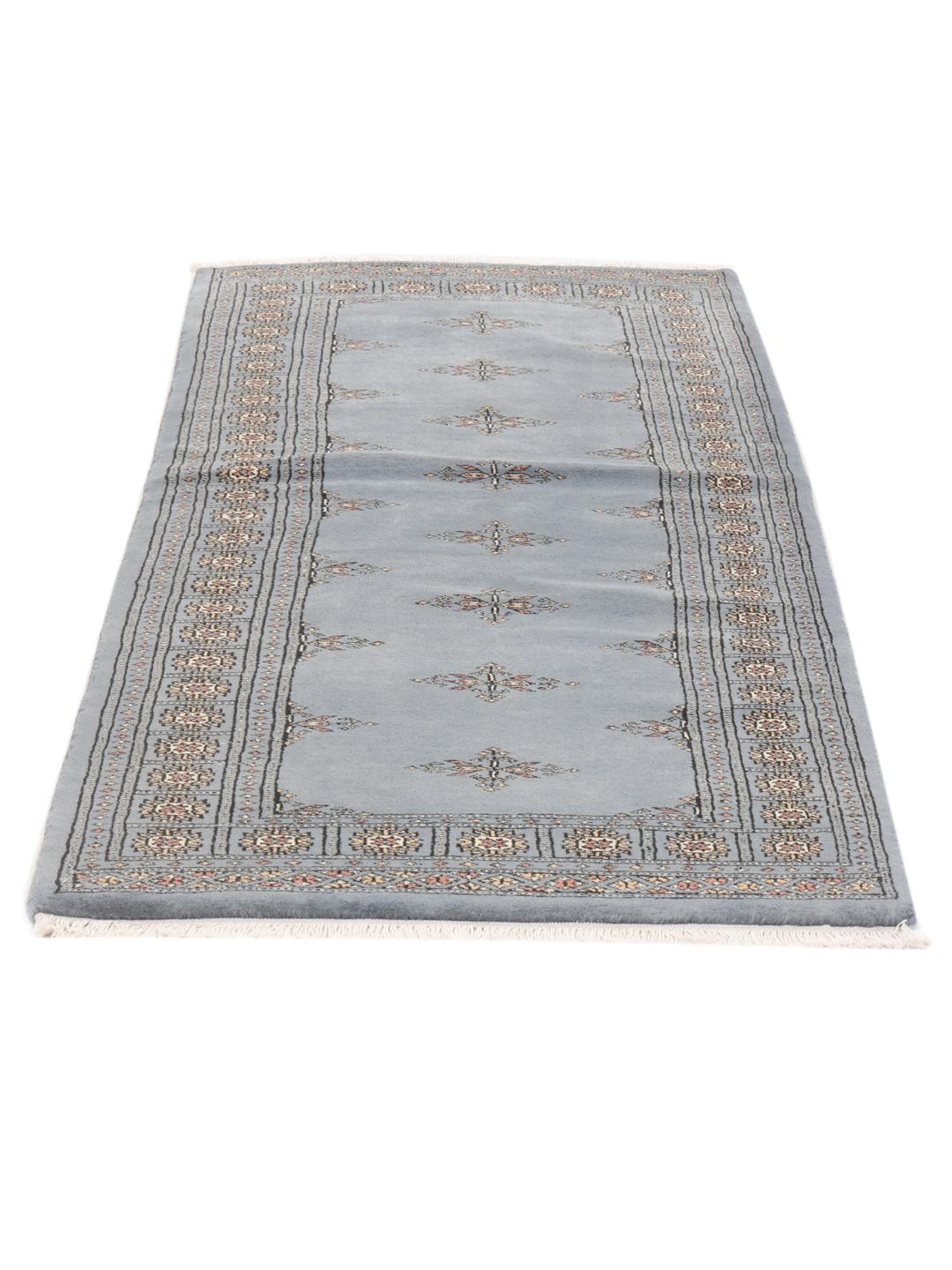 A hand-knotted blue runner from Pakistan with a traditional motif