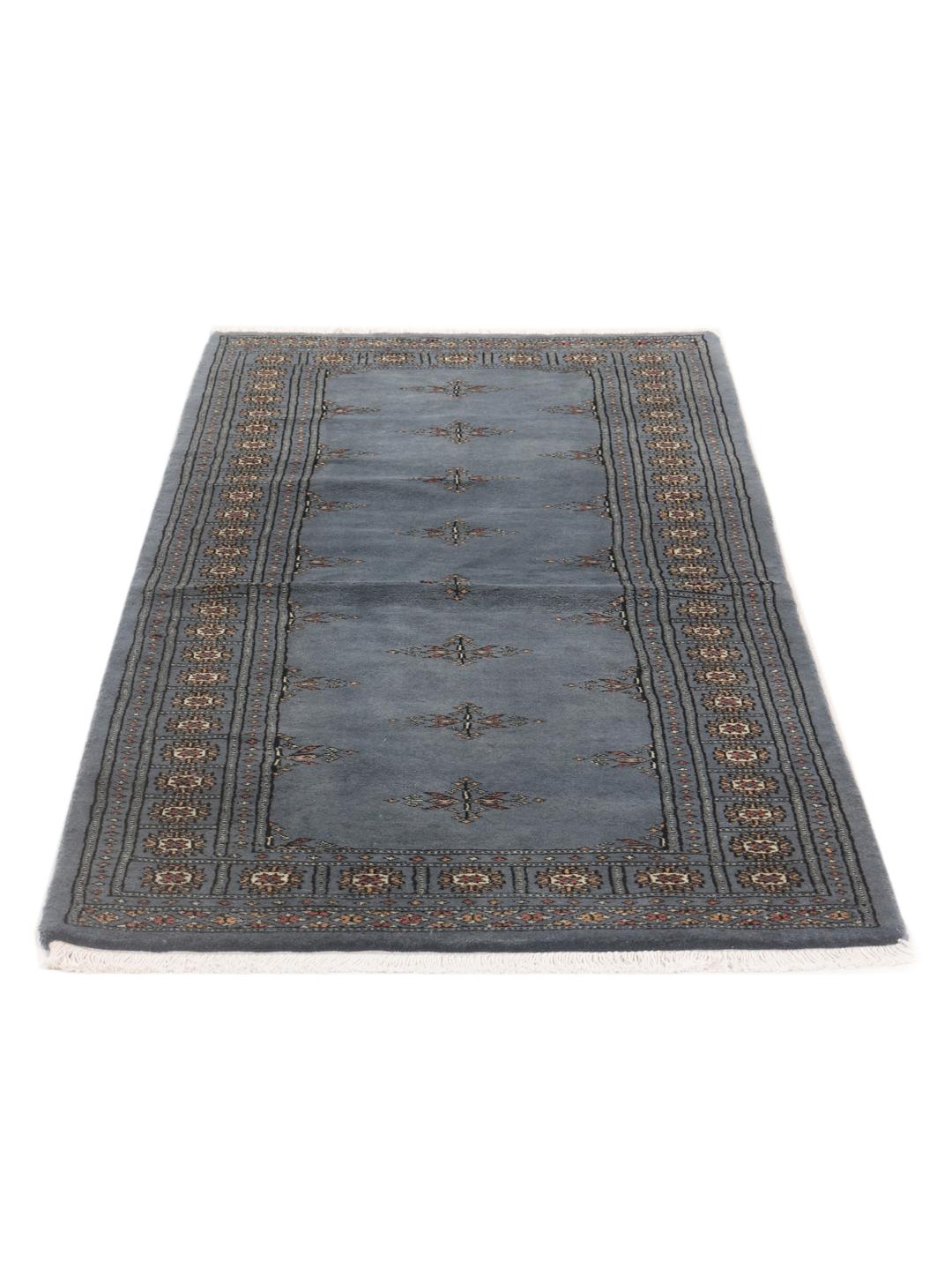 A hand-knotted blue runner from Pakistan with a traditional motif