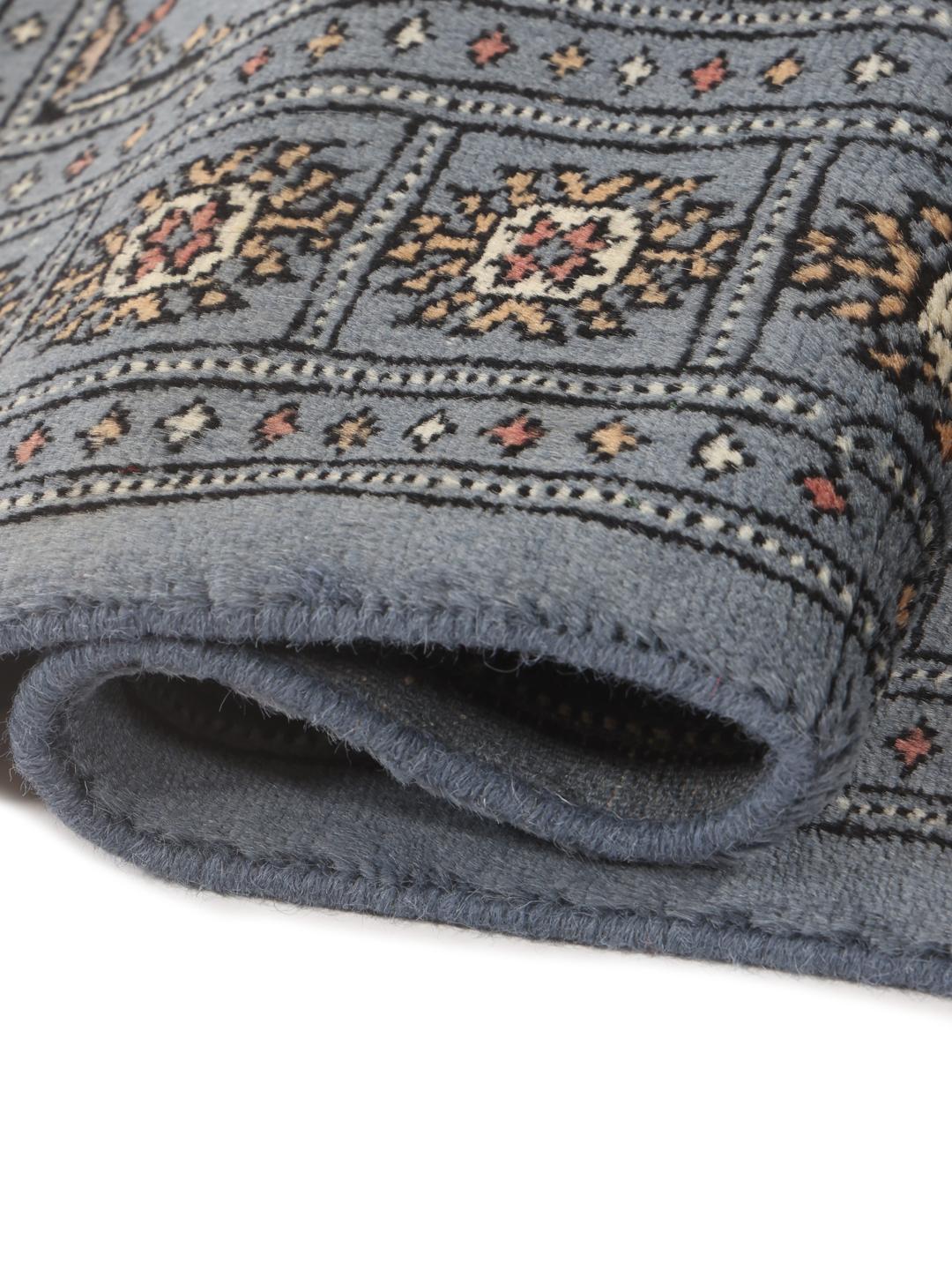 A hand-knotted blue runner from Pakistan with a traditional motif