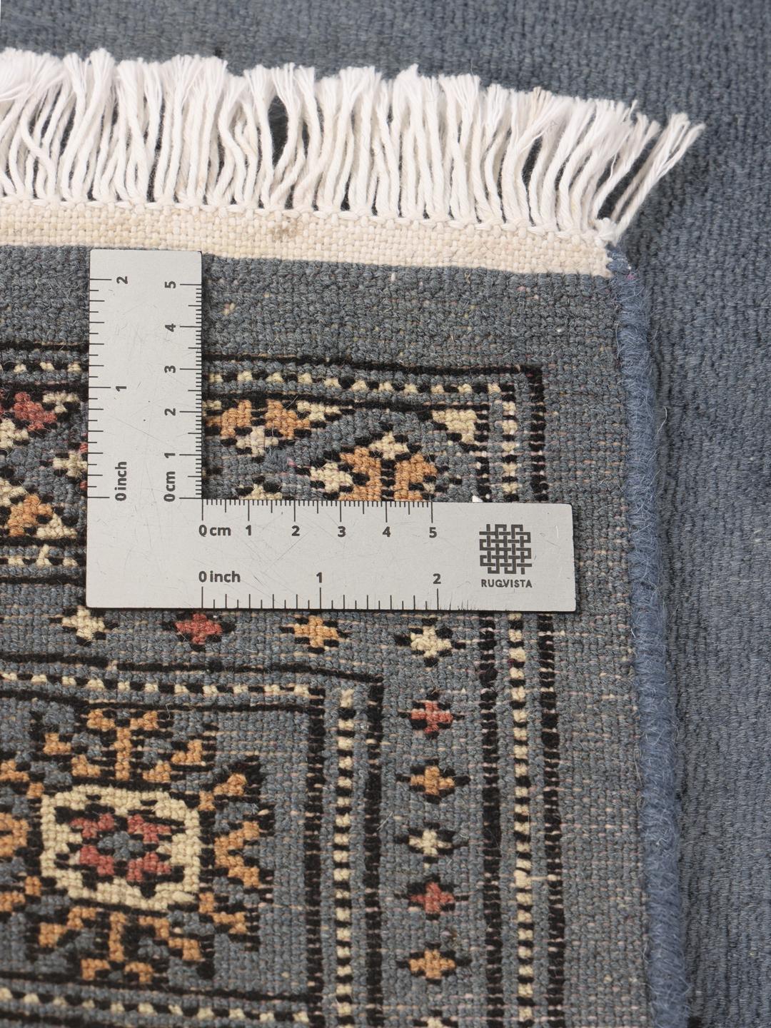 A hand-knotted blue runner from Pakistan with a traditional motif