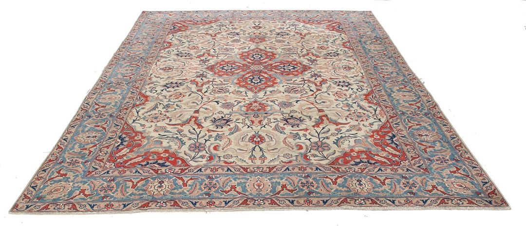 Antique Isfahan rug from the Middle East in beige, red, and blue tones