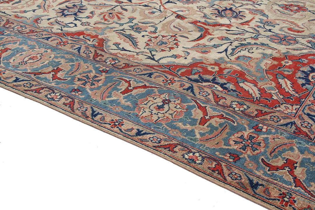 Antique Isfahan rug from the Middle East in beige, red, and blue tones