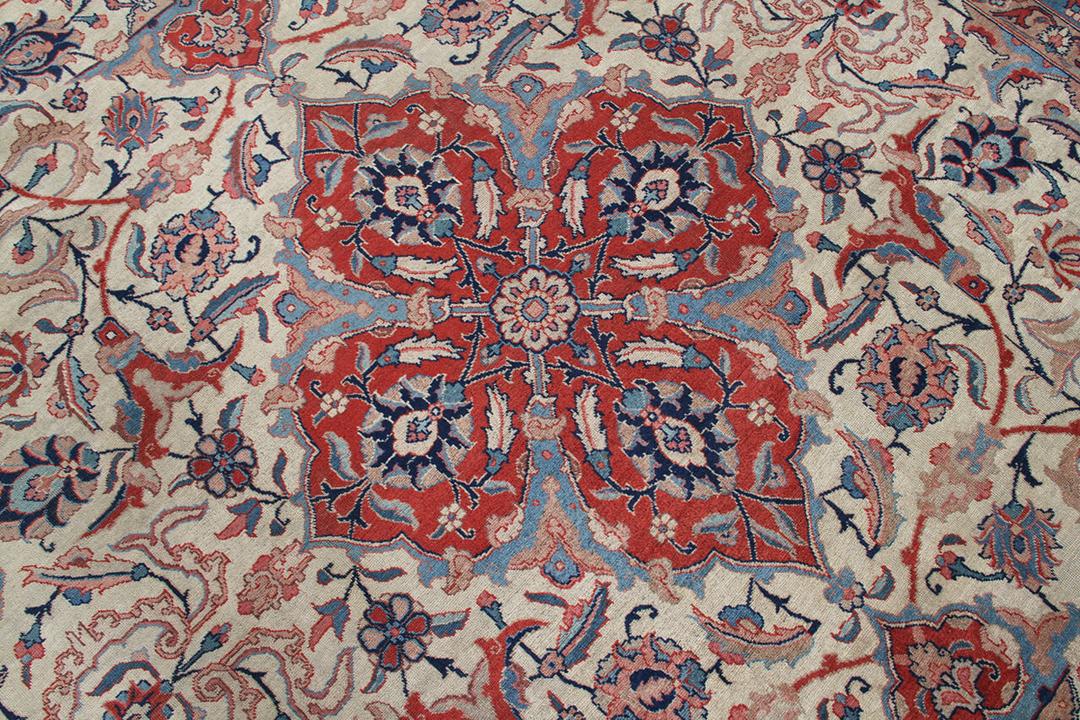 Antique Isfahan rug from the Middle East in beige, red, and blue tones