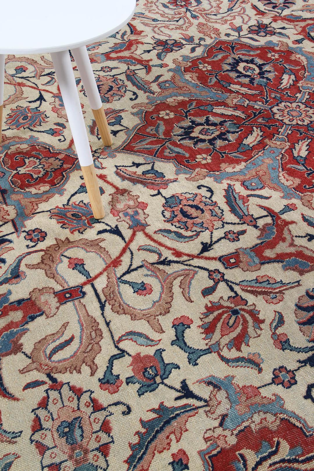 Antique Isfahan rug from the Middle East in beige, red, and blue tones