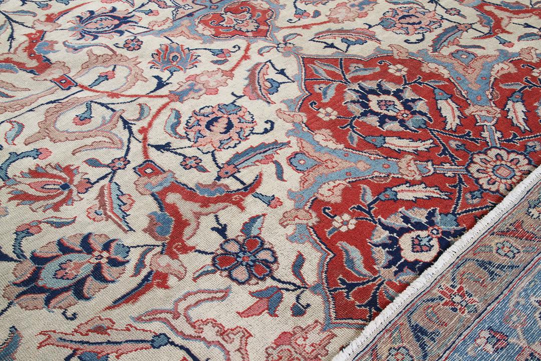 Antique Isfahan rug from the Middle East in beige, red, and blue tones