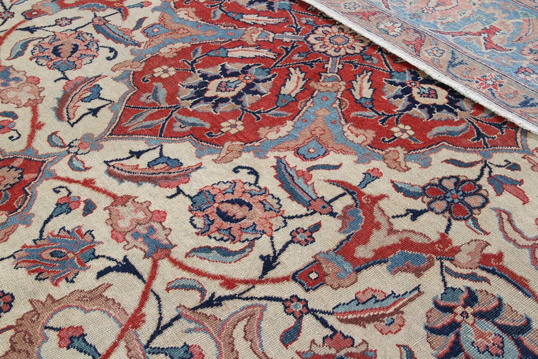 Antique Isfahan rug from the Middle East in beige, red, and blue tones