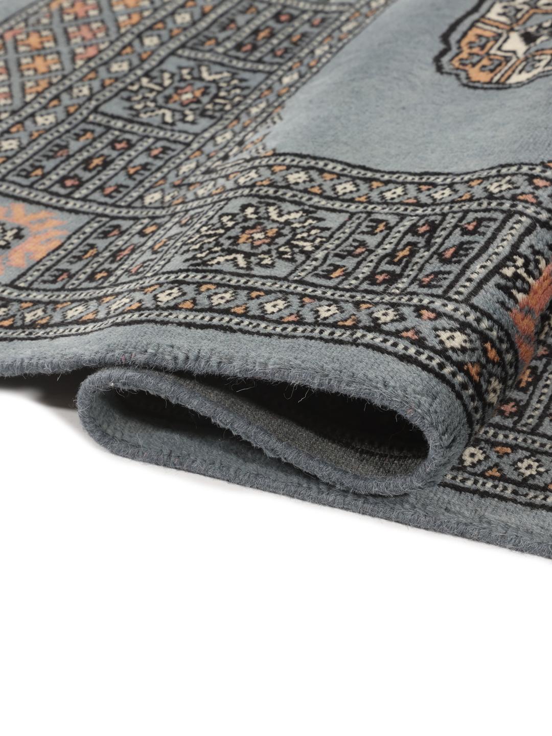 Hand-knotted blue runner from Pakistan featuring traditional repeating motifs