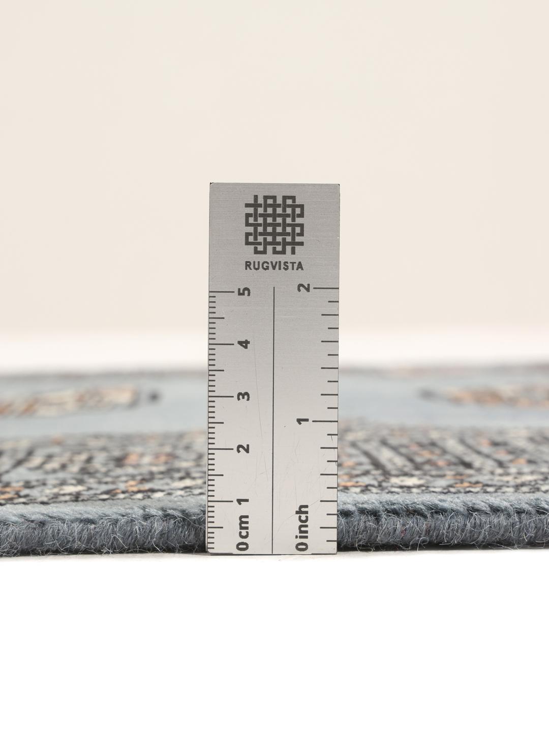 Hand-knotted blue runner from Pakistan featuring traditional repeating motifs
