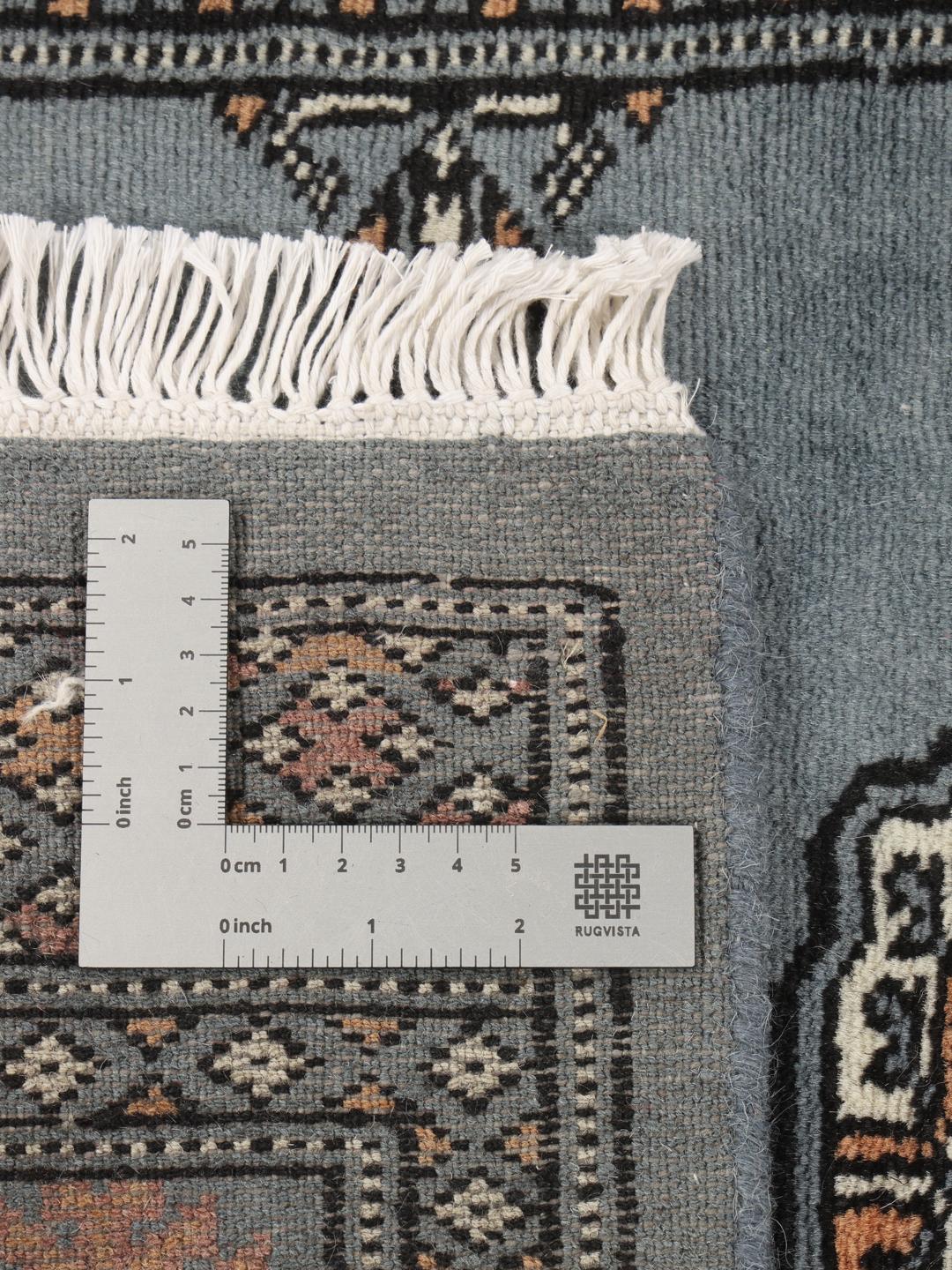 Hand-knotted blue runner from Pakistan featuring traditional repeating motifs