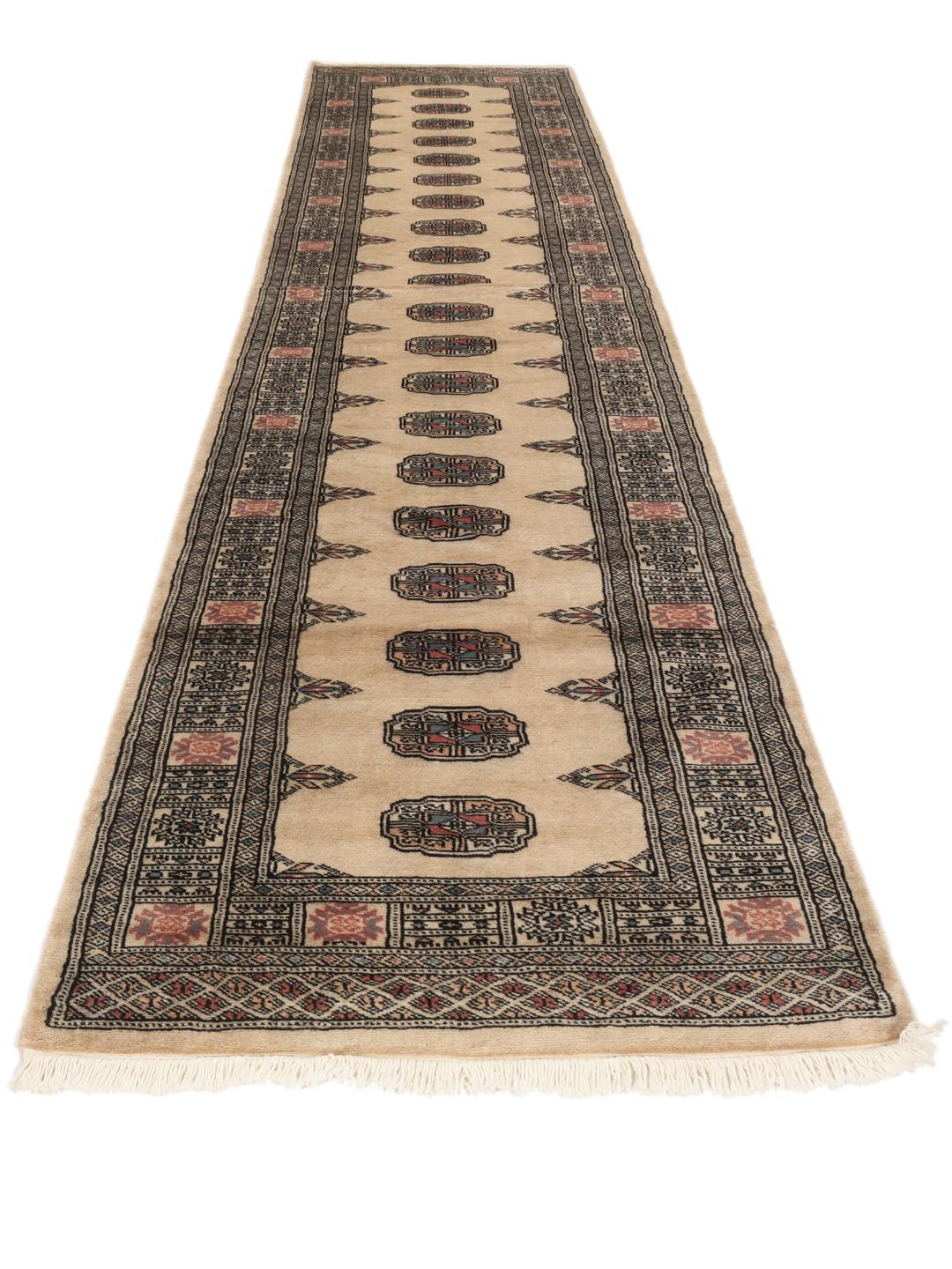 Hand-knotted Pakistan Bokhara runner with beige field and medallion patterns