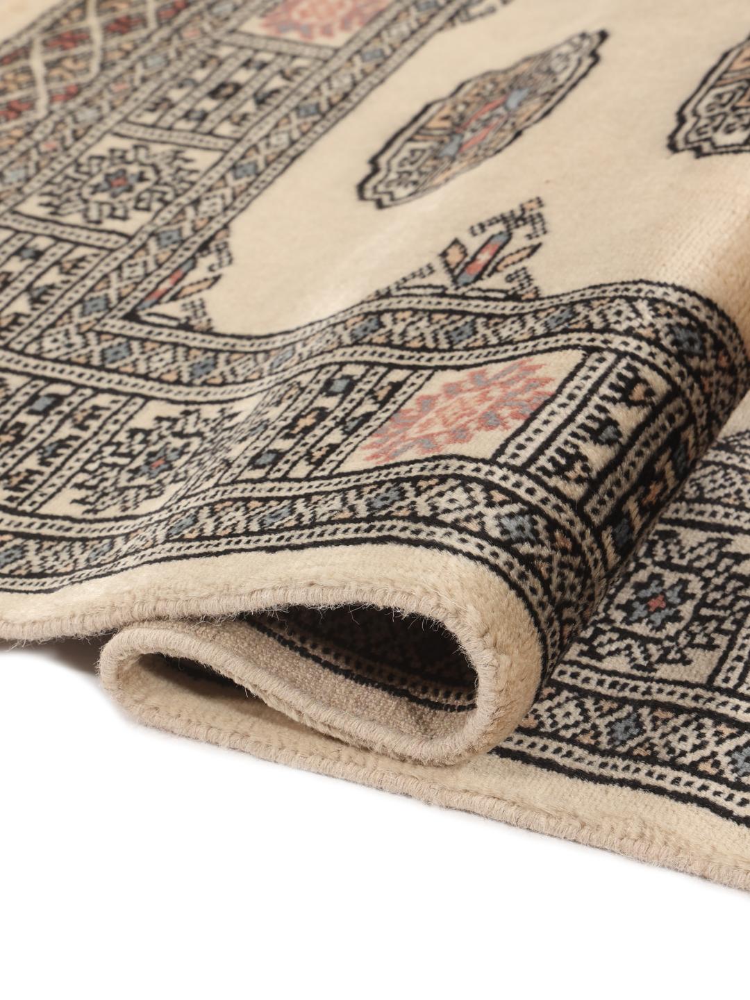 Hand-knotted Pakistan Bokhara runner with beige field and medallion patterns