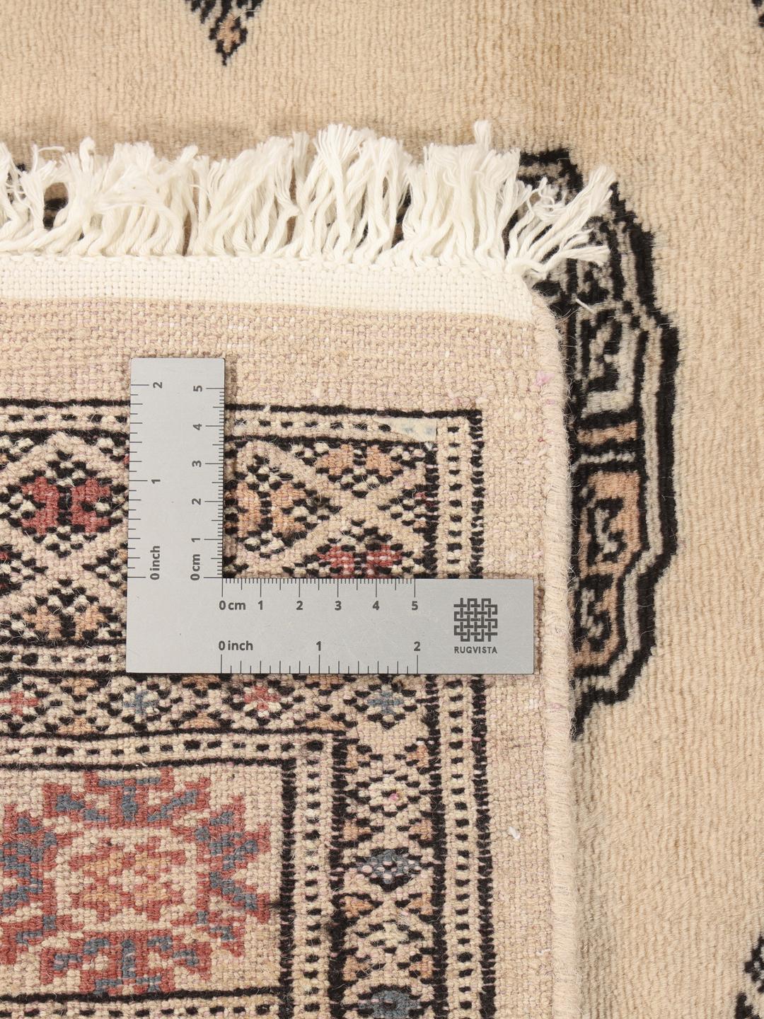 Hand-knotted Pakistan Bokhara runner with beige field and medallion patterns