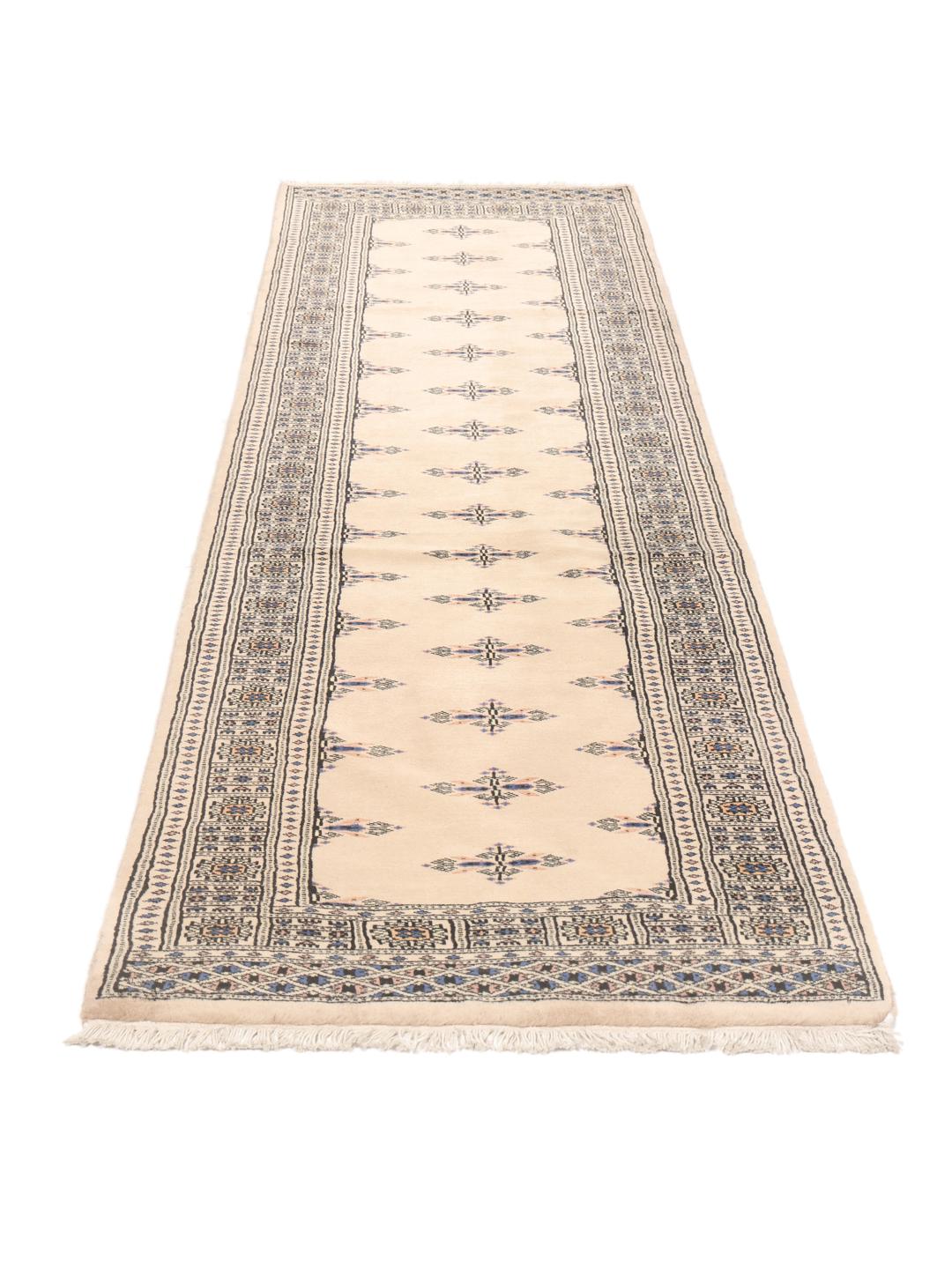 Hand-knotted beige runner rug from Pakistan with traditional motifs