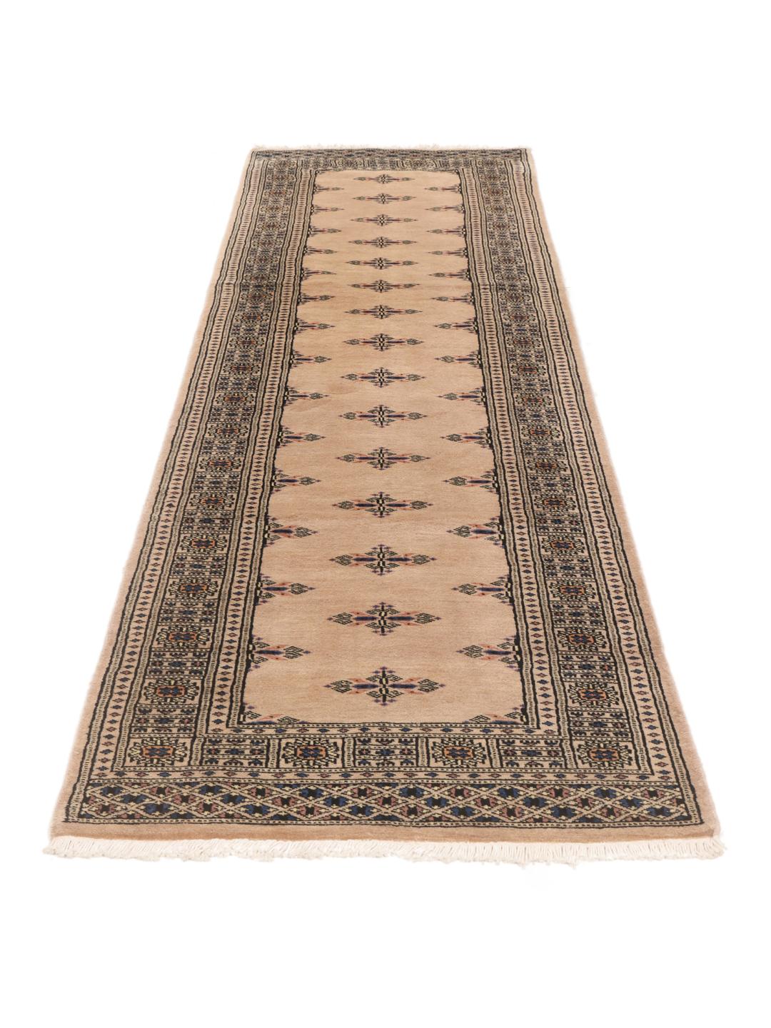 Hand-knotted beige runner rug from Pakistan with traditional motifs