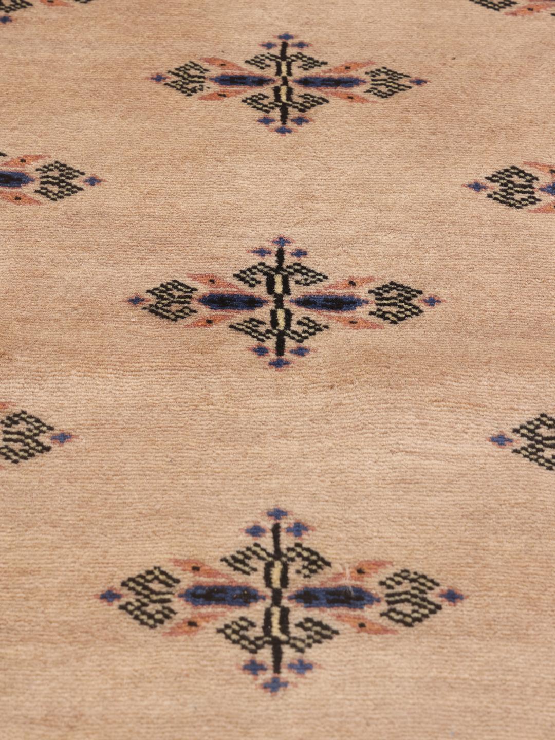 Hand-knotted beige runner rug from Pakistan with traditional motifs