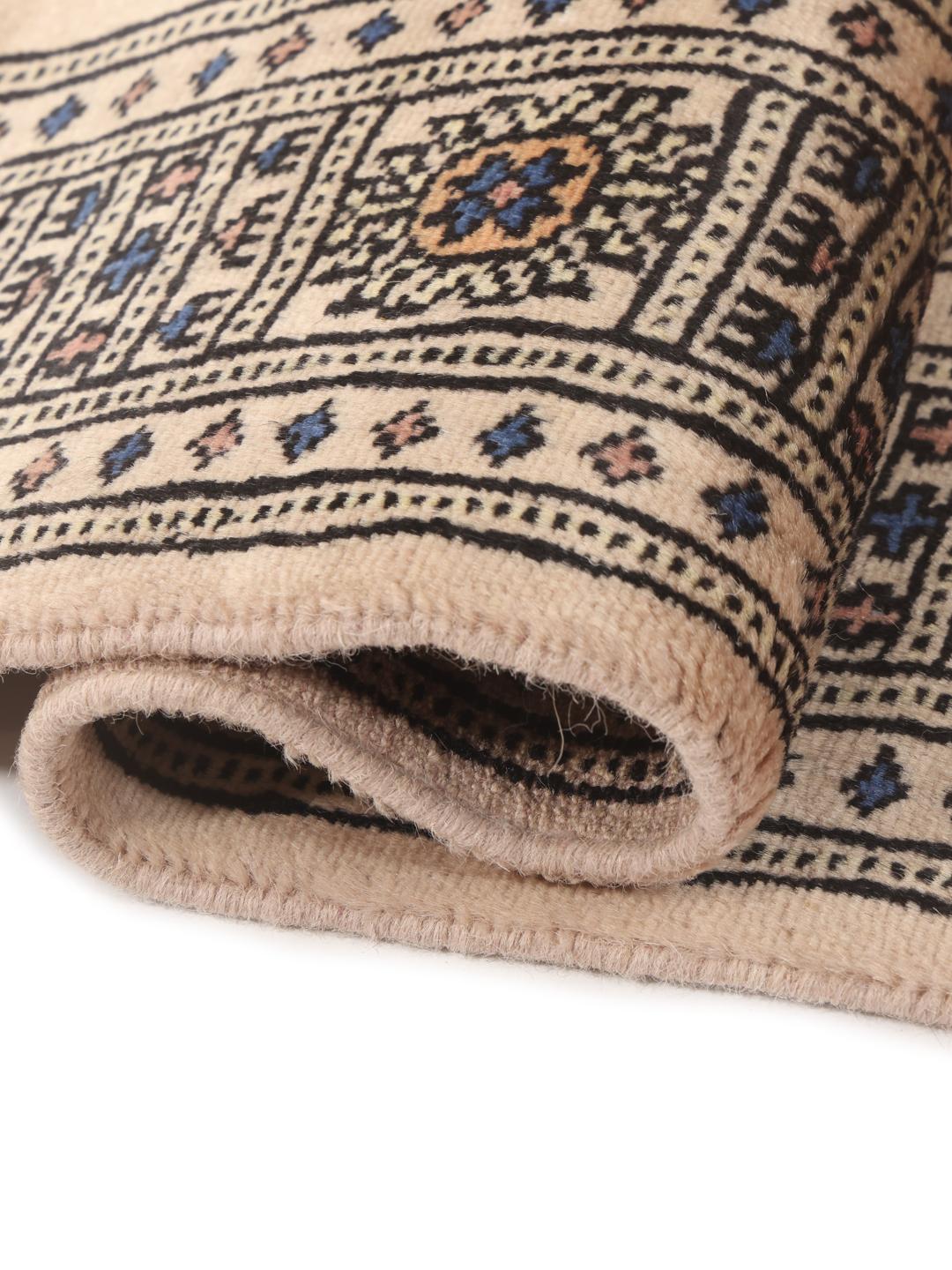 Hand-knotted beige runner rug from Pakistan with traditional motifs