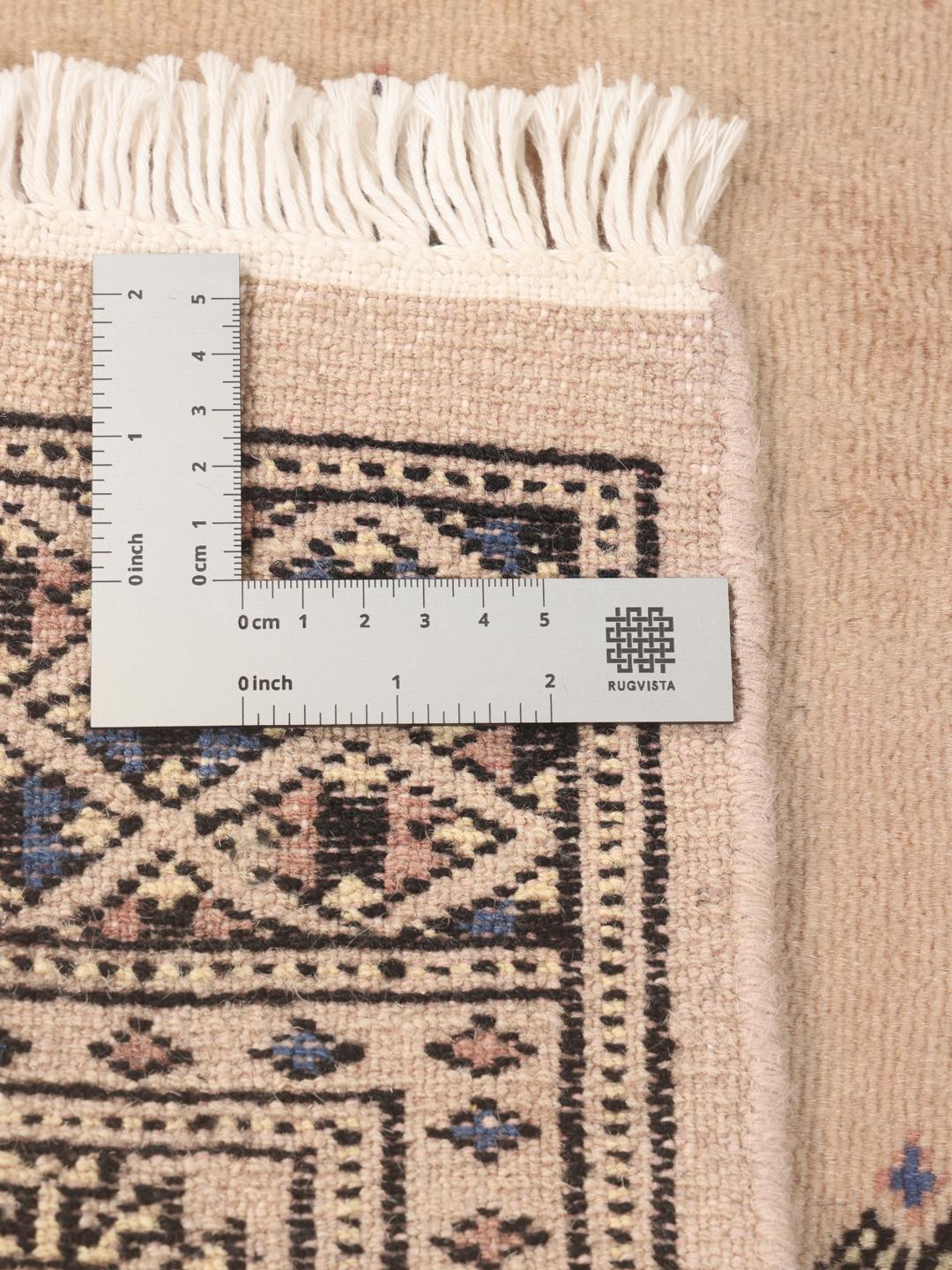 Hand-knotted beige runner rug from Pakistan with traditional motifs