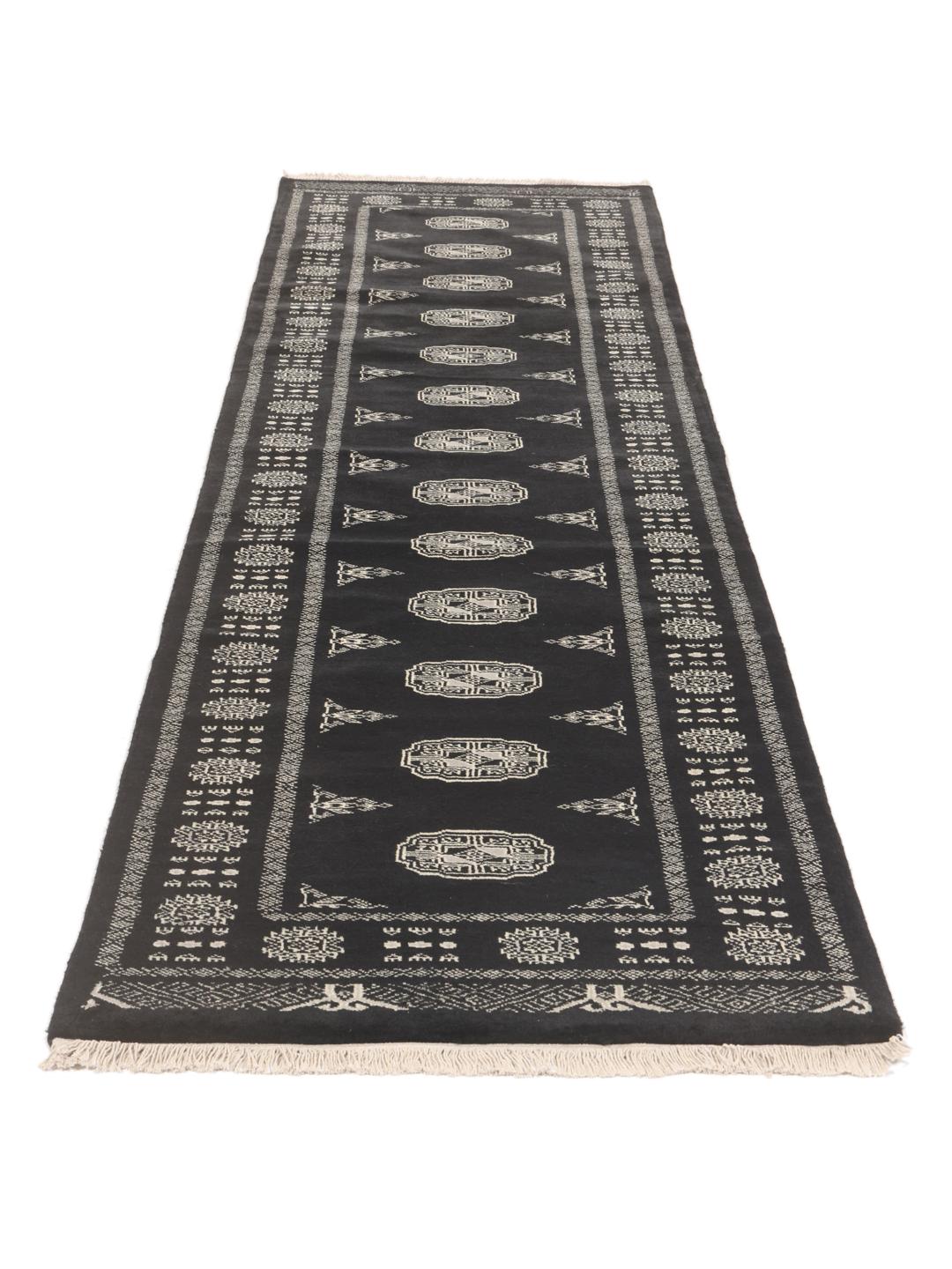 Hand-knotted black runner from Pakistan with traditional geometric patterns