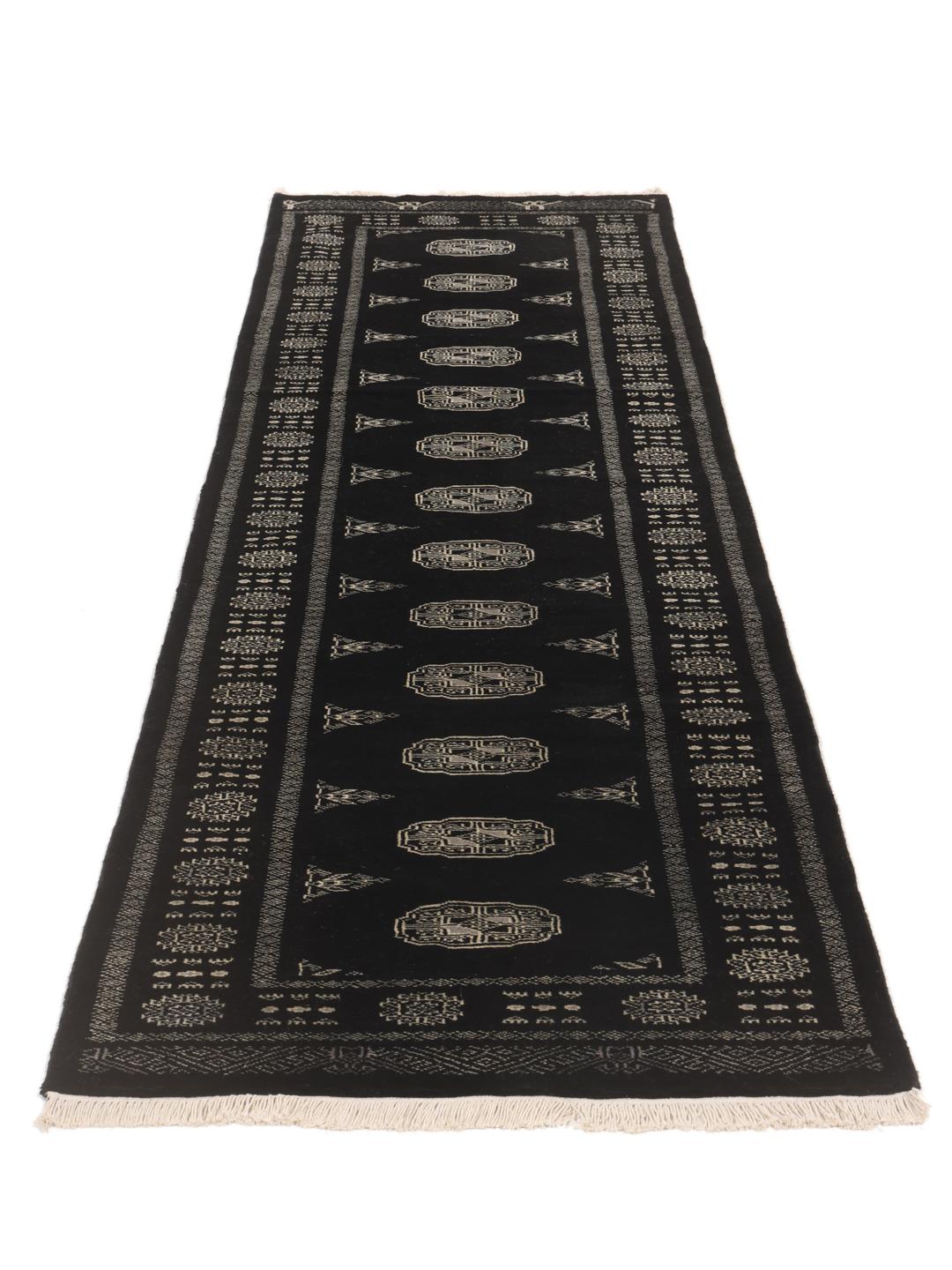 Hand-knotted black runner from Pakistan with traditional geometric patterns