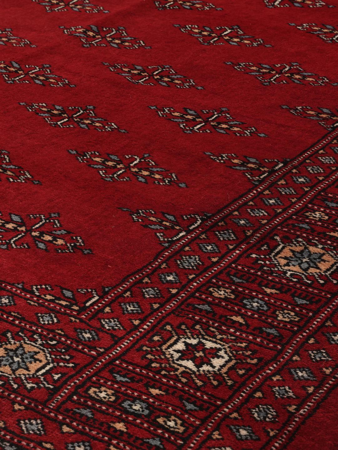 Hand-knotted Pakistan Bokhara 3ply rug in dark-red with traditional motifs