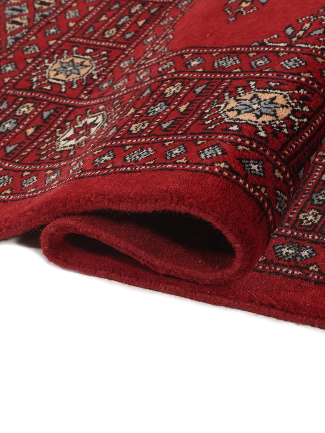 Hand-knotted Pakistan Bokhara 3ply rug in dark-red with traditional motifs