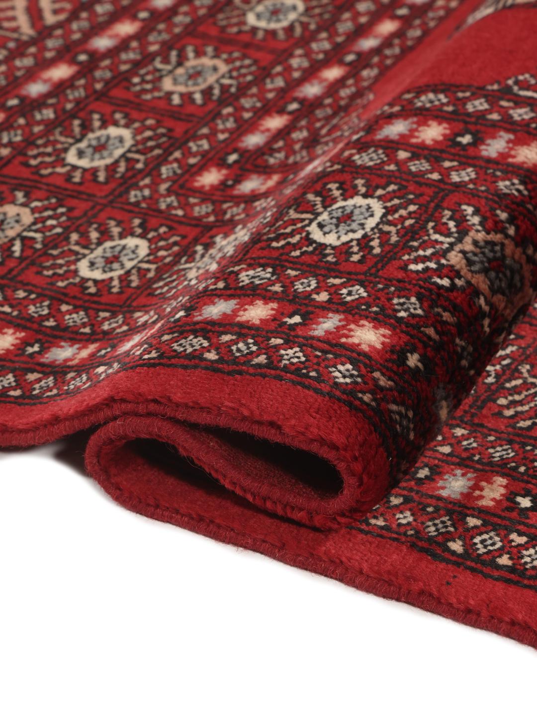 Hand-knotted Pakistan Bokhara 3ply rug with traditional red field and geometric motifs