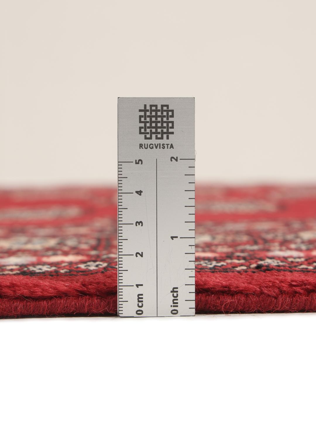 Hand-knotted Pakistan Bokhara 3ply rug with traditional red field and geometric motifs
