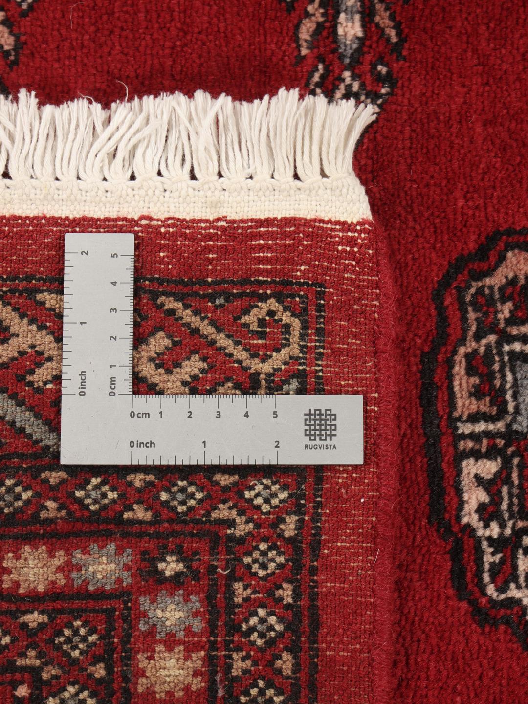 Hand-knotted Pakistan Bokhara 3ply rug with traditional red field and geometric motifs