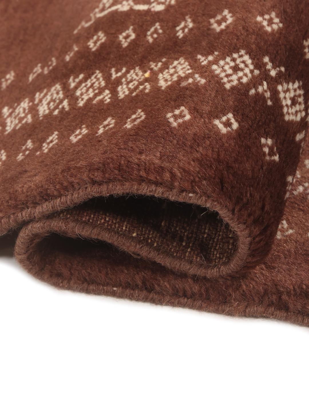 Hand-knotted Pakistan Bokhara rug in deep brown with traditional motifs