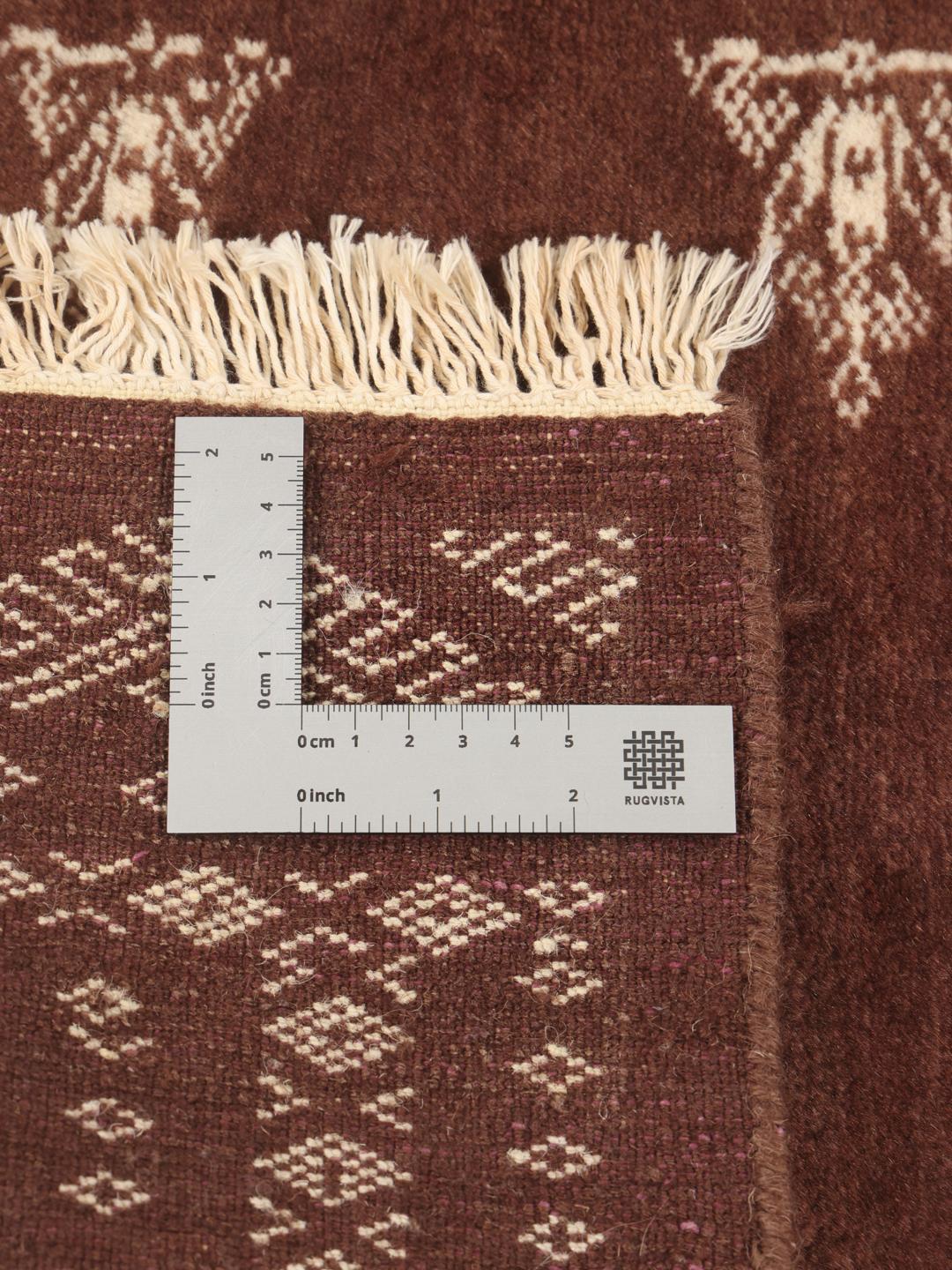 Hand-knotted Pakistan Bokhara rug in deep brown with traditional motifs