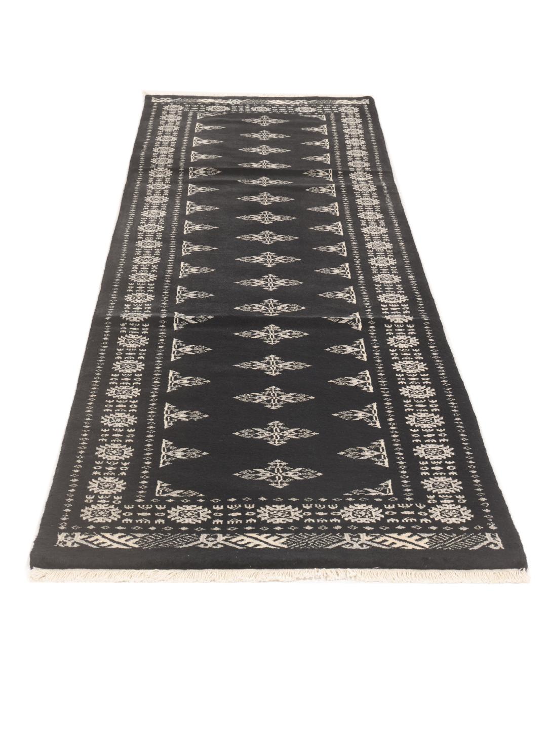 Hand-knotted black runner rug from Pakistan with ivory geometric motifs