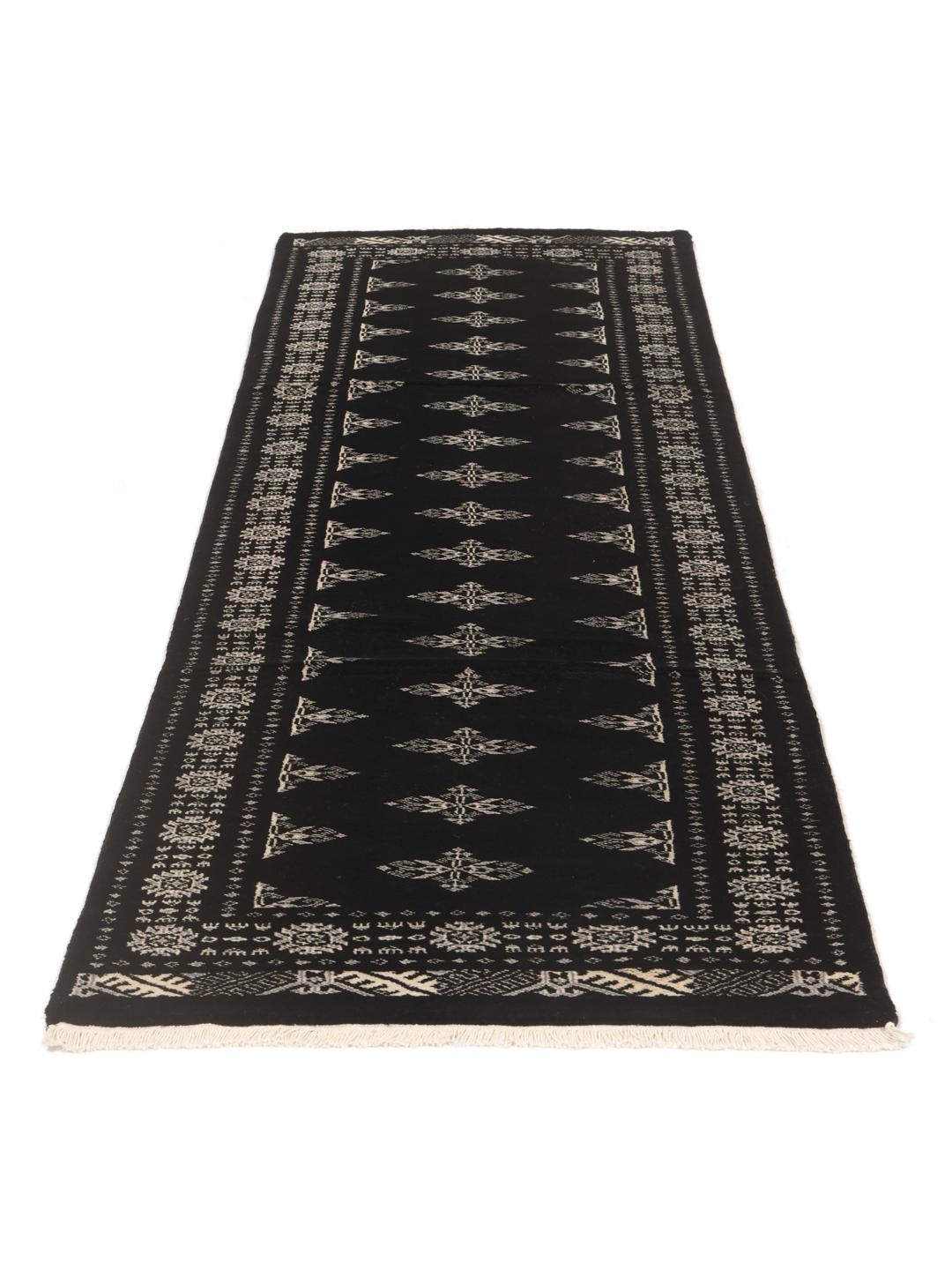 Hand-knotted black runner rug from Pakistan with ivory geometric motifs