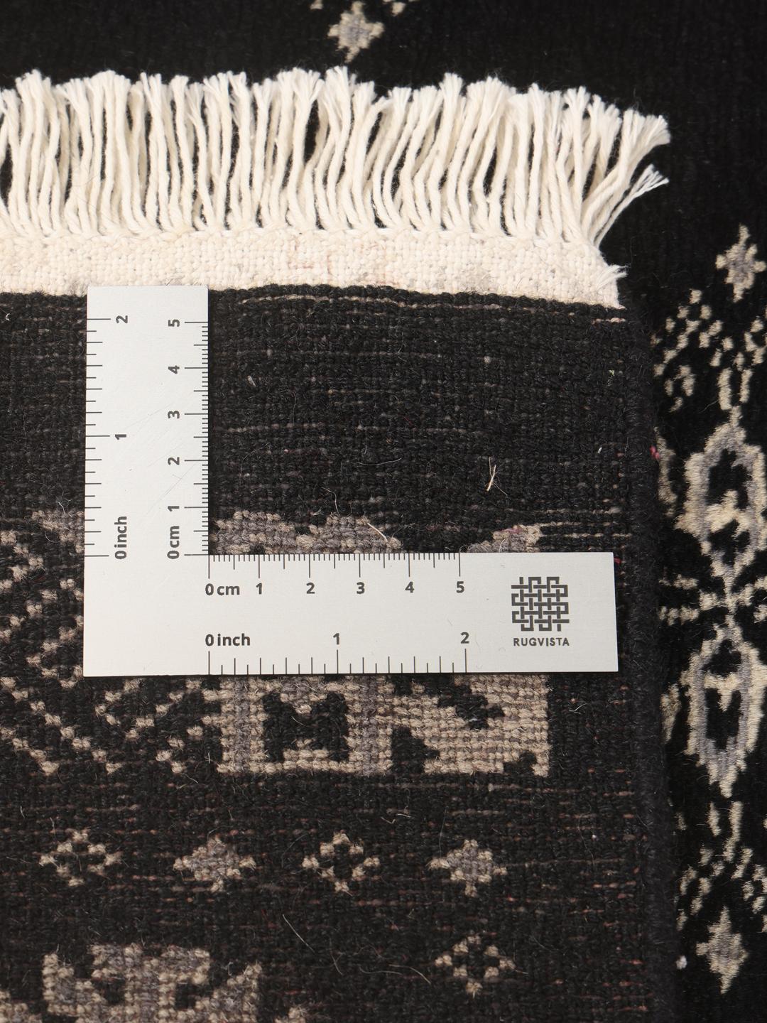 Hand-knotted black runner rug from Pakistan with ivory geometric motifs