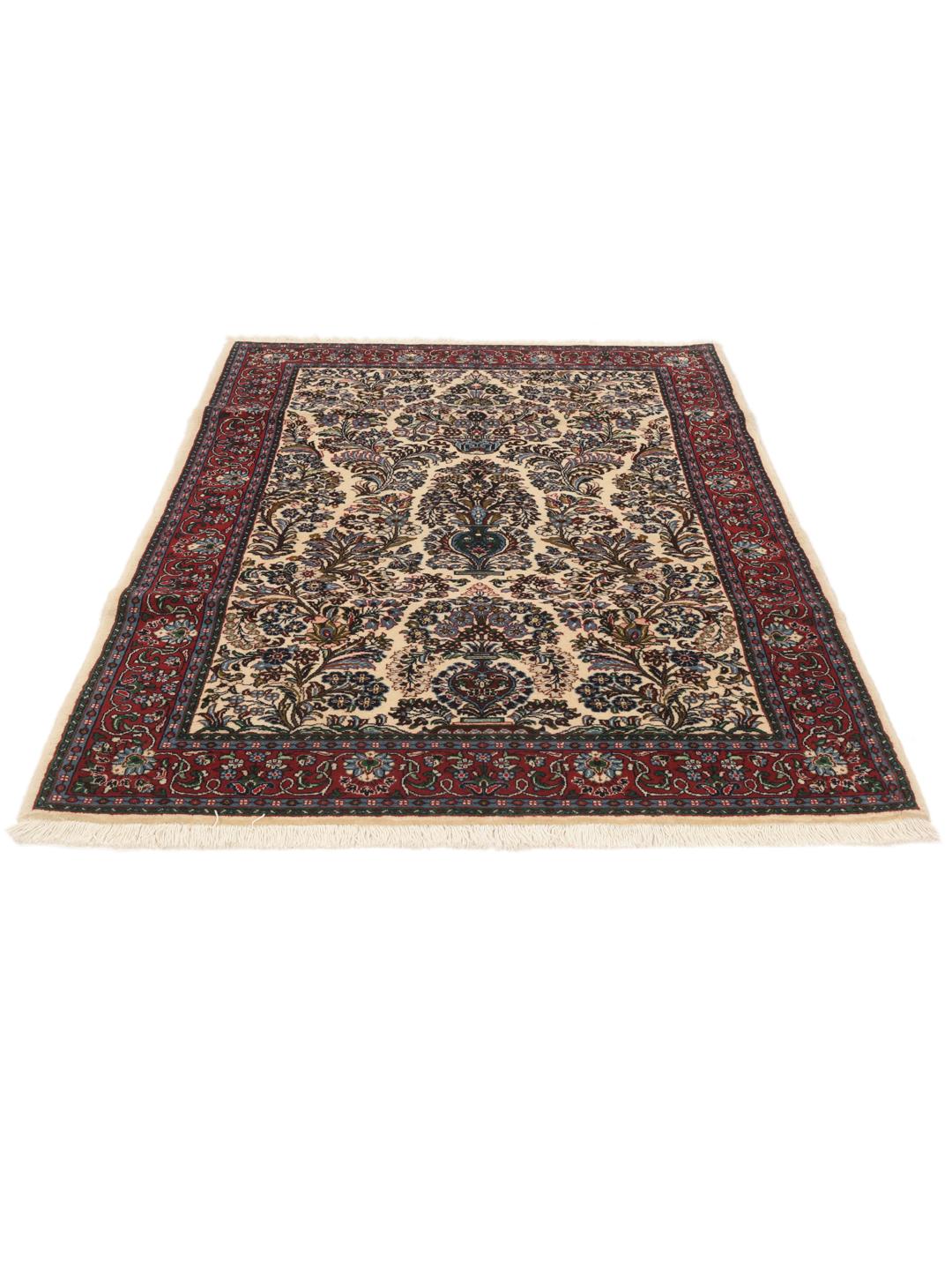 Hand-knotted Sarough rug with a floral vase pattern in red and beige tones.