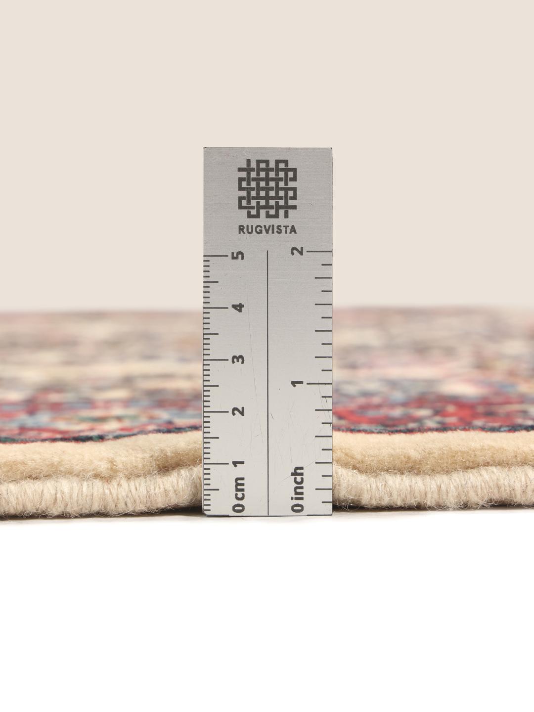 Hand-knotted Sarough rug with a floral vase pattern in red and beige tones.