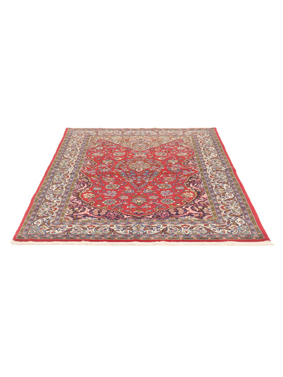 A hand-knotted Sarough rug from the Middle East featuring a vibrant red field with intricate floral patterns.