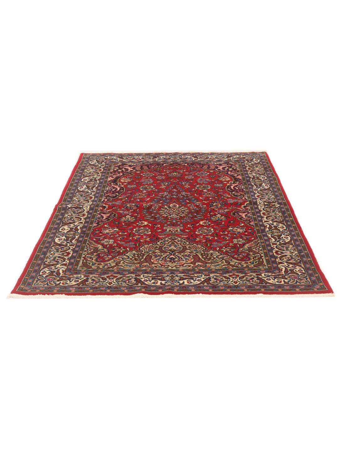 A hand-knotted Sarough rug from the Middle East featuring a vibrant red field with intricate floral patterns.